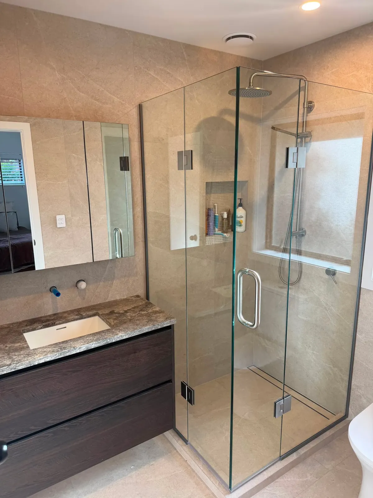 Finished bathroom renovation with glass shower and floating vanity by Watcon Projects, Drury